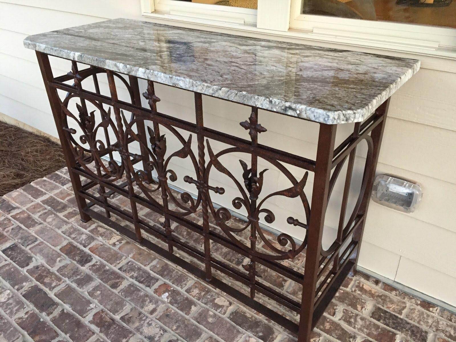 Granite-topped console table on an ornate wrought iron base