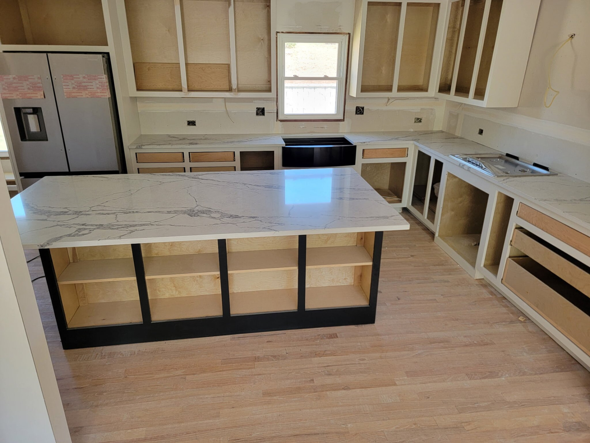 White quartz island with bold gray veining on a black base