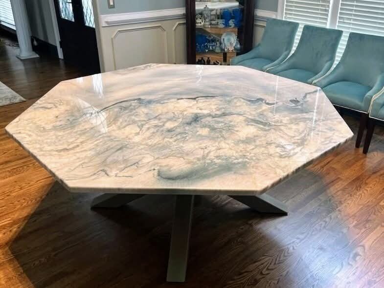 Custom octagonal marble table with gray veining on a pedestal base