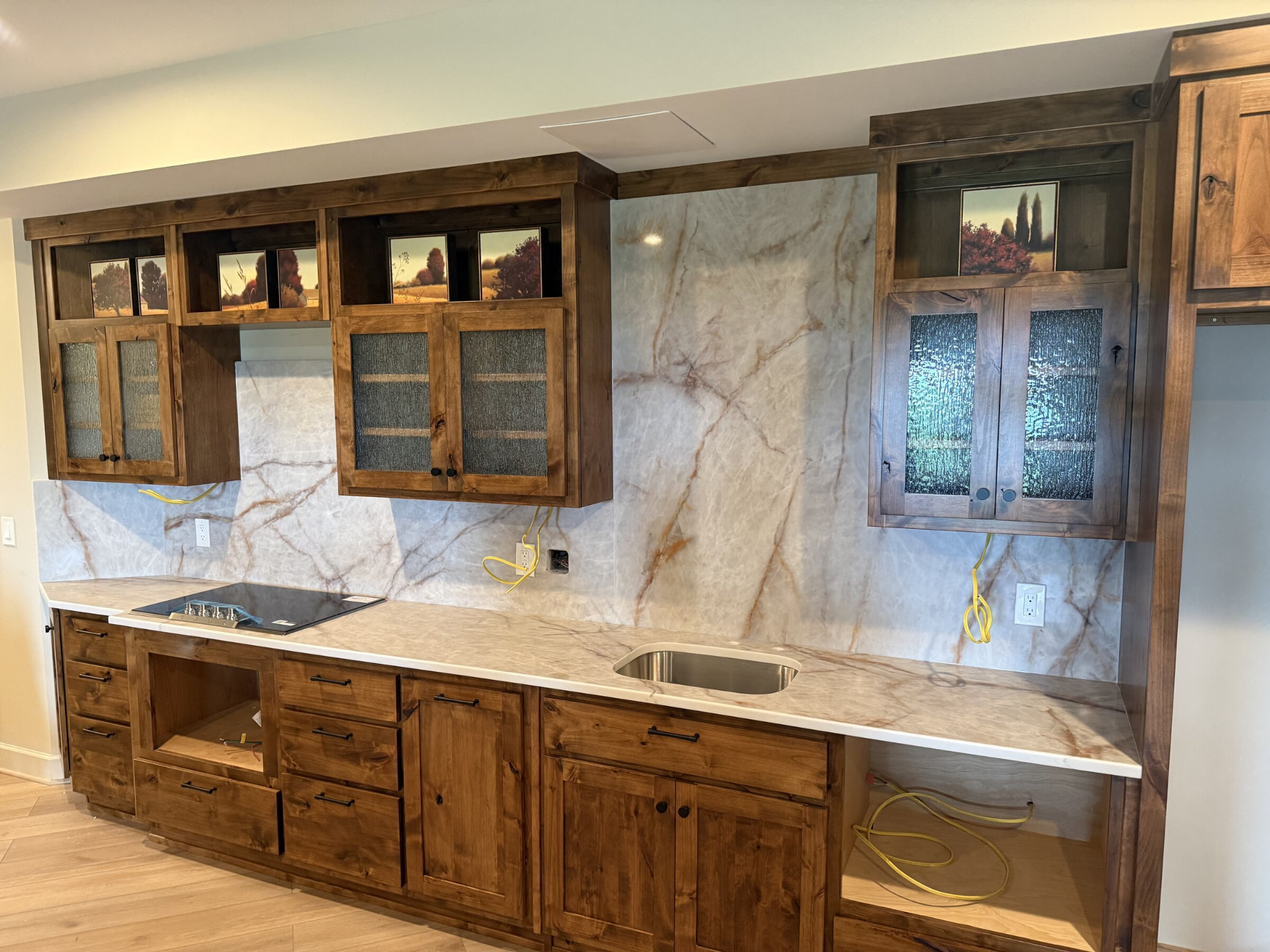 Kitchen with quartzite countertops and a full-height matching stone backsplash