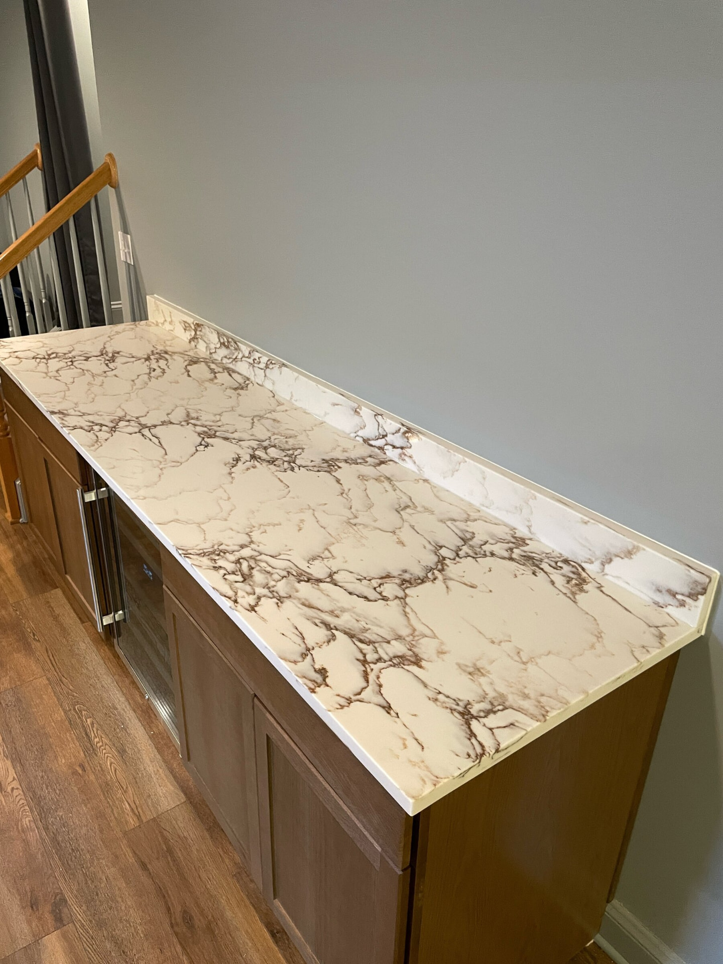 White and gold-veined stone counter on a built-in bar
