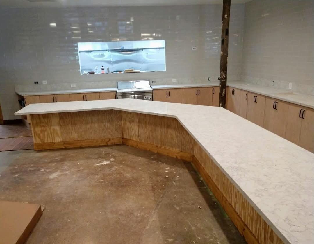 Angled quartz service counter in a commercial kitchen