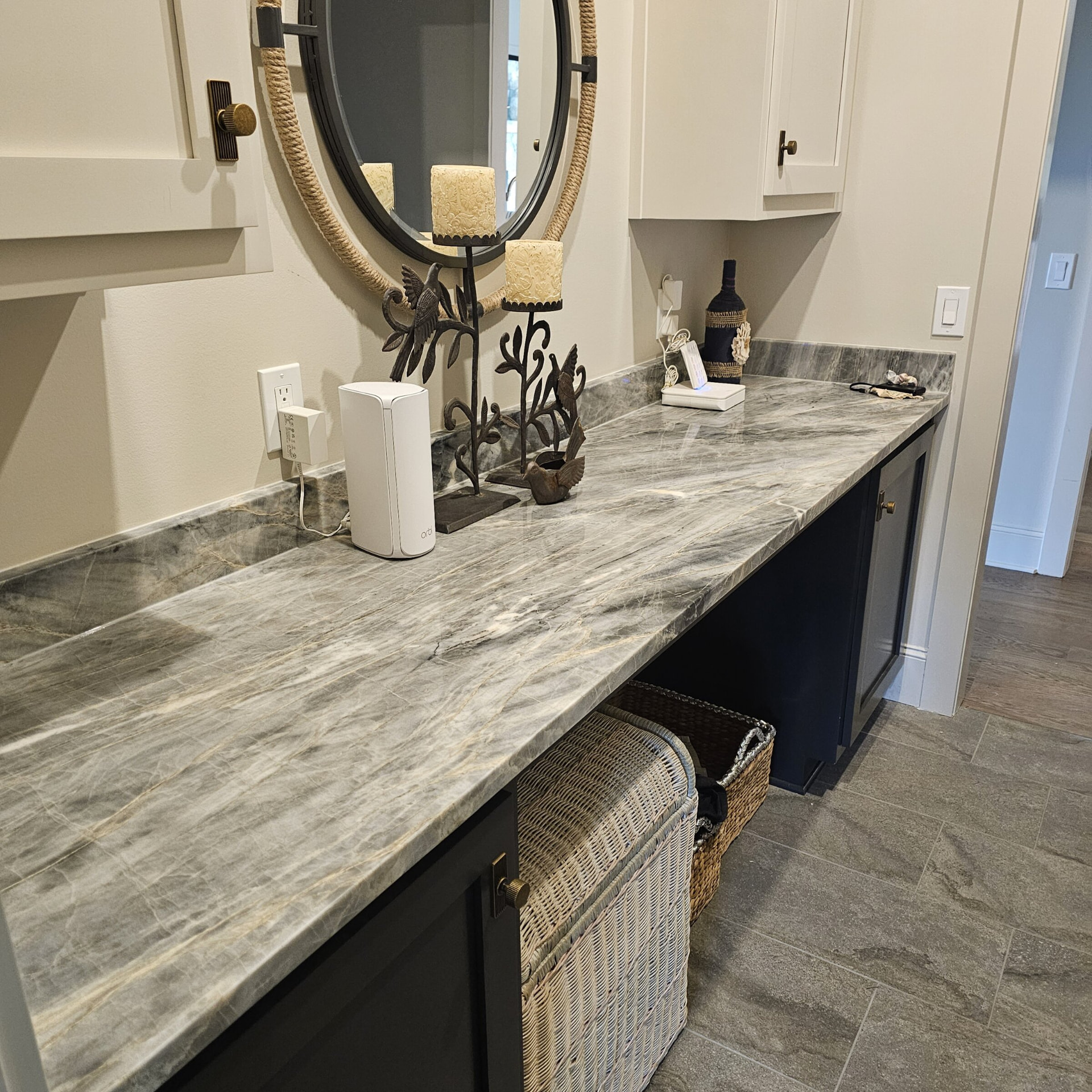 Long gray quartzite vanity counter with matching backsplash