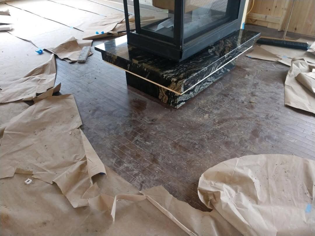 Black and gold granite pedestal hearth for a fireplace