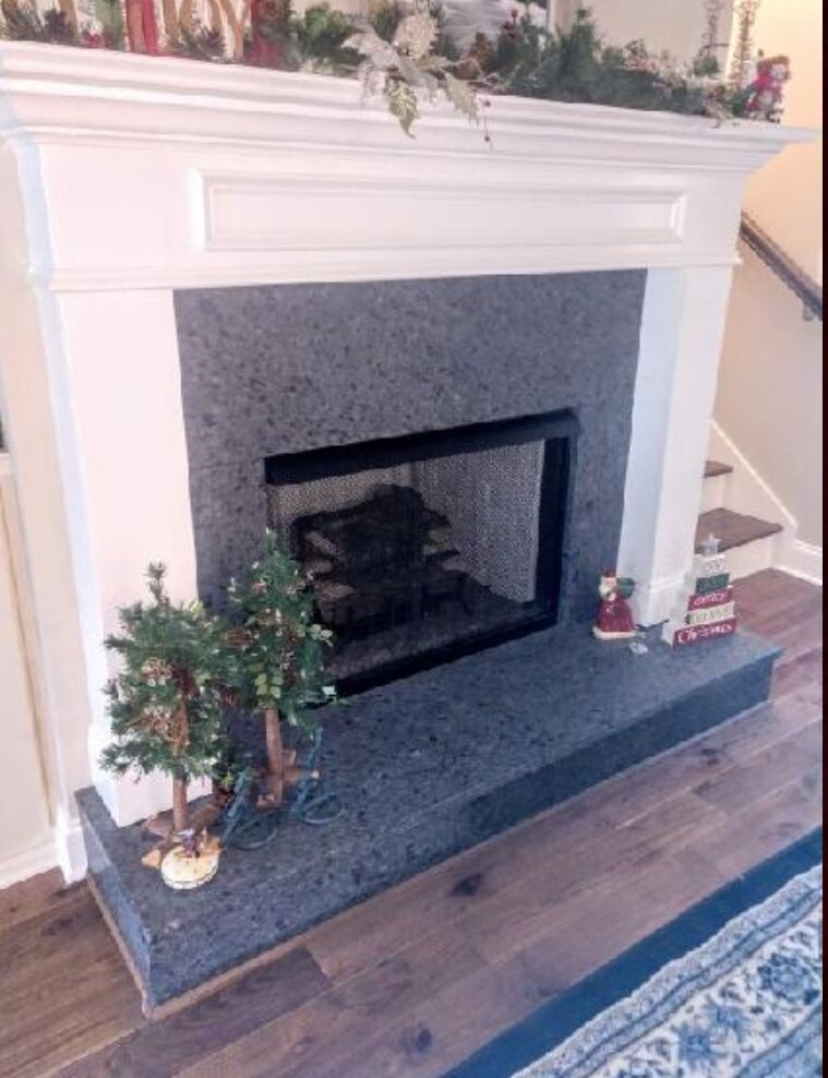Gray granite fireplace surround and raised hearth