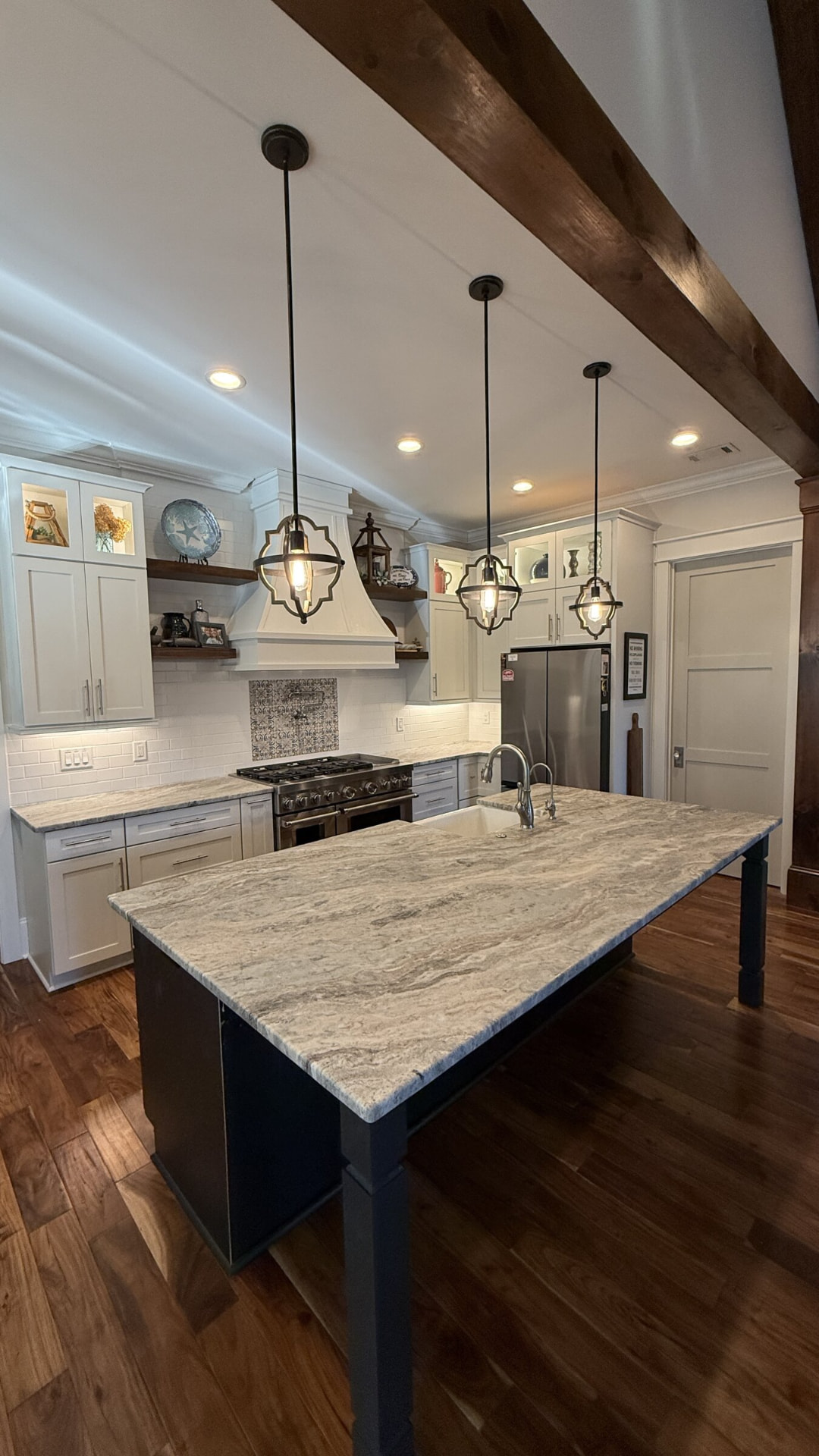 Large veined granite island with a farmhouse sink